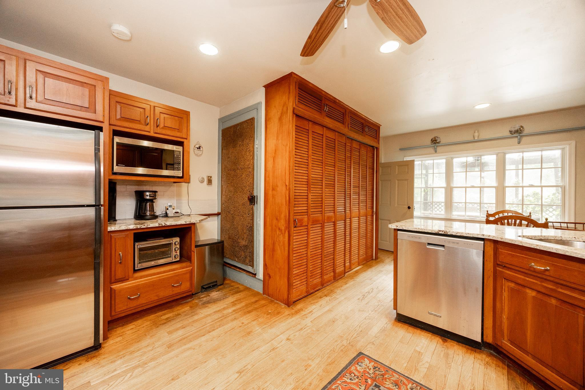 1699 Warpath Road West Chester, PA 19382 - Photo 16 of 65 a kitchen with stainless steel appliances granite countertop a refrigerator and wooden cabinets