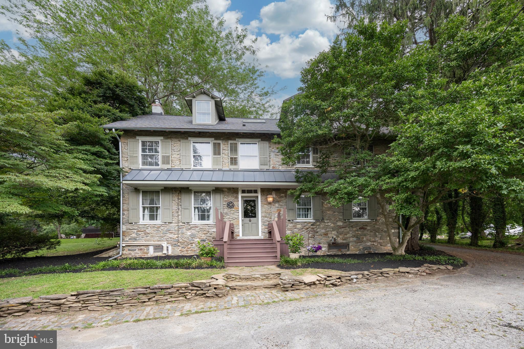 1699 Warpath Road West Chester, PA 19382 - Photo 2 of 65 a view of a house with a yard and large trees
