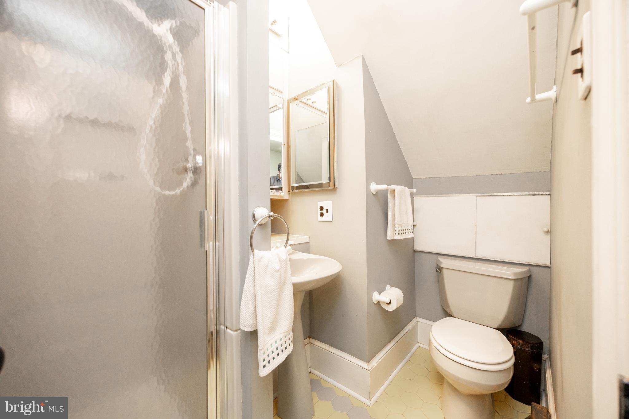 1699 Warpath Road West Chester, PA 19382 - Photo 21 of 65 a white toilet sitting next to a bathroom sink and a shower