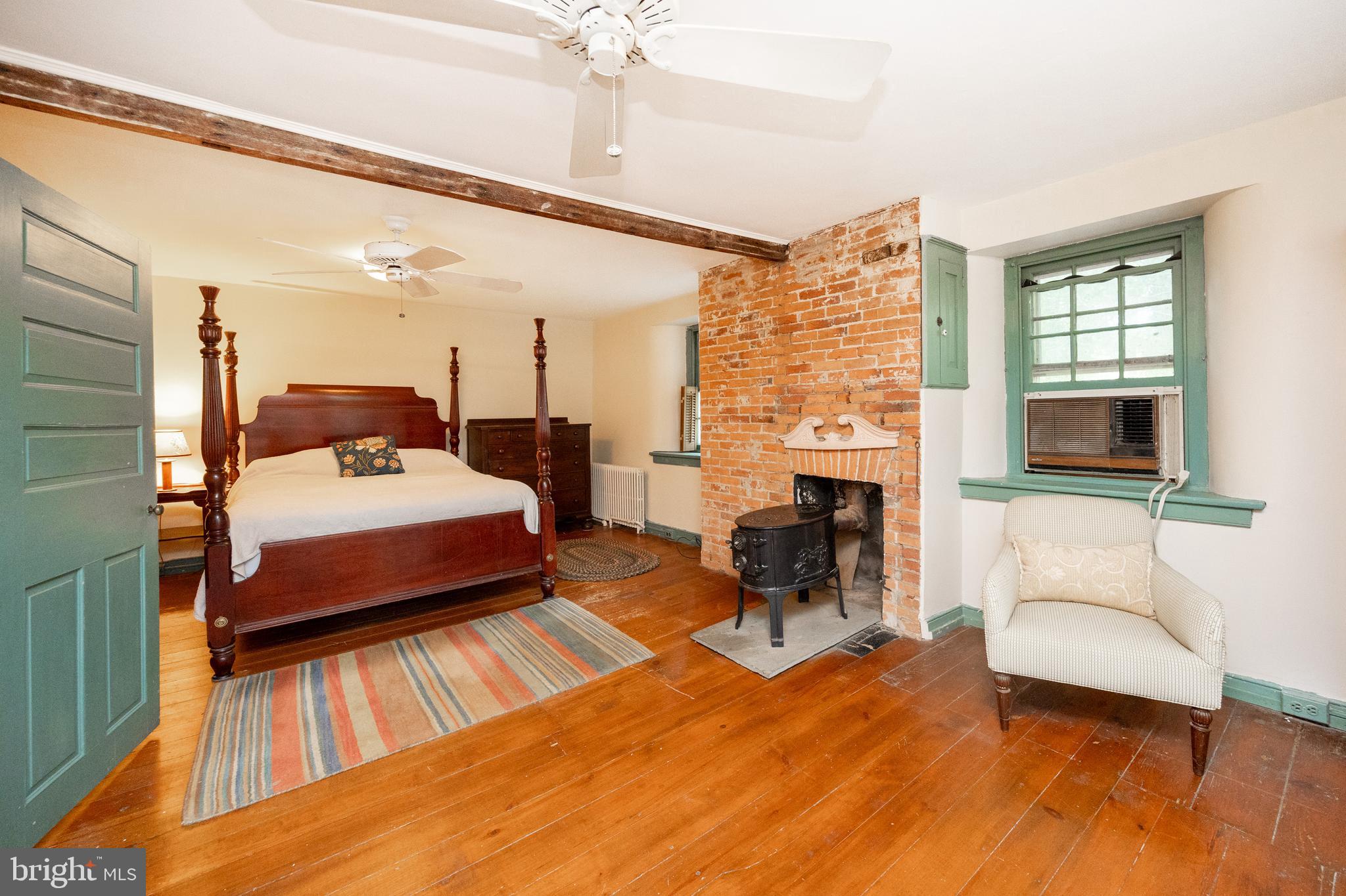 1699 Warpath Road West Chester, PA 19382 - Photo 29 of 65 a bedroom with a bed and a fireplace