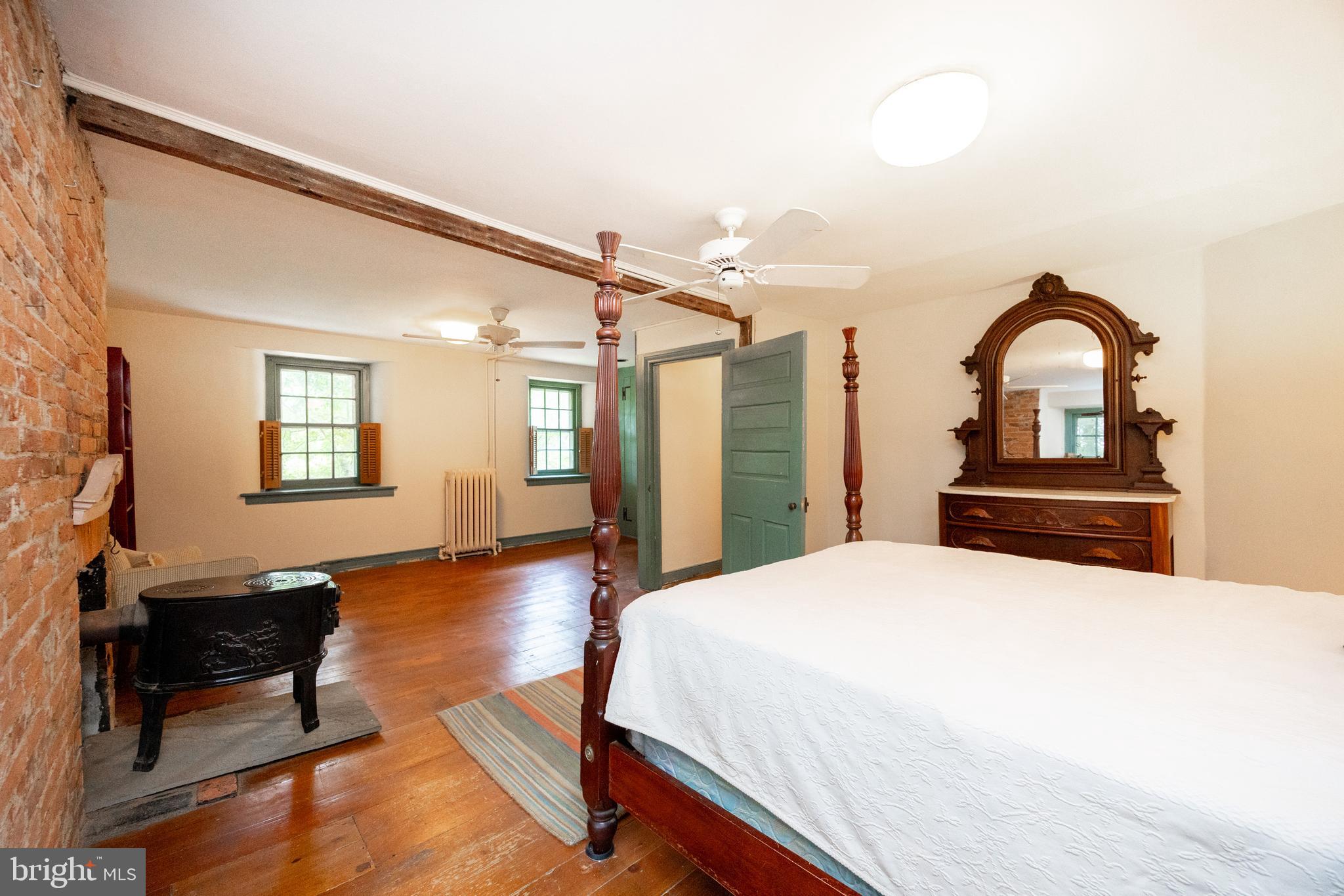1699 Warpath Road West Chester, PA 19382 - Photo 30 of 65 a spacious bedroom with a bed and wooden floor