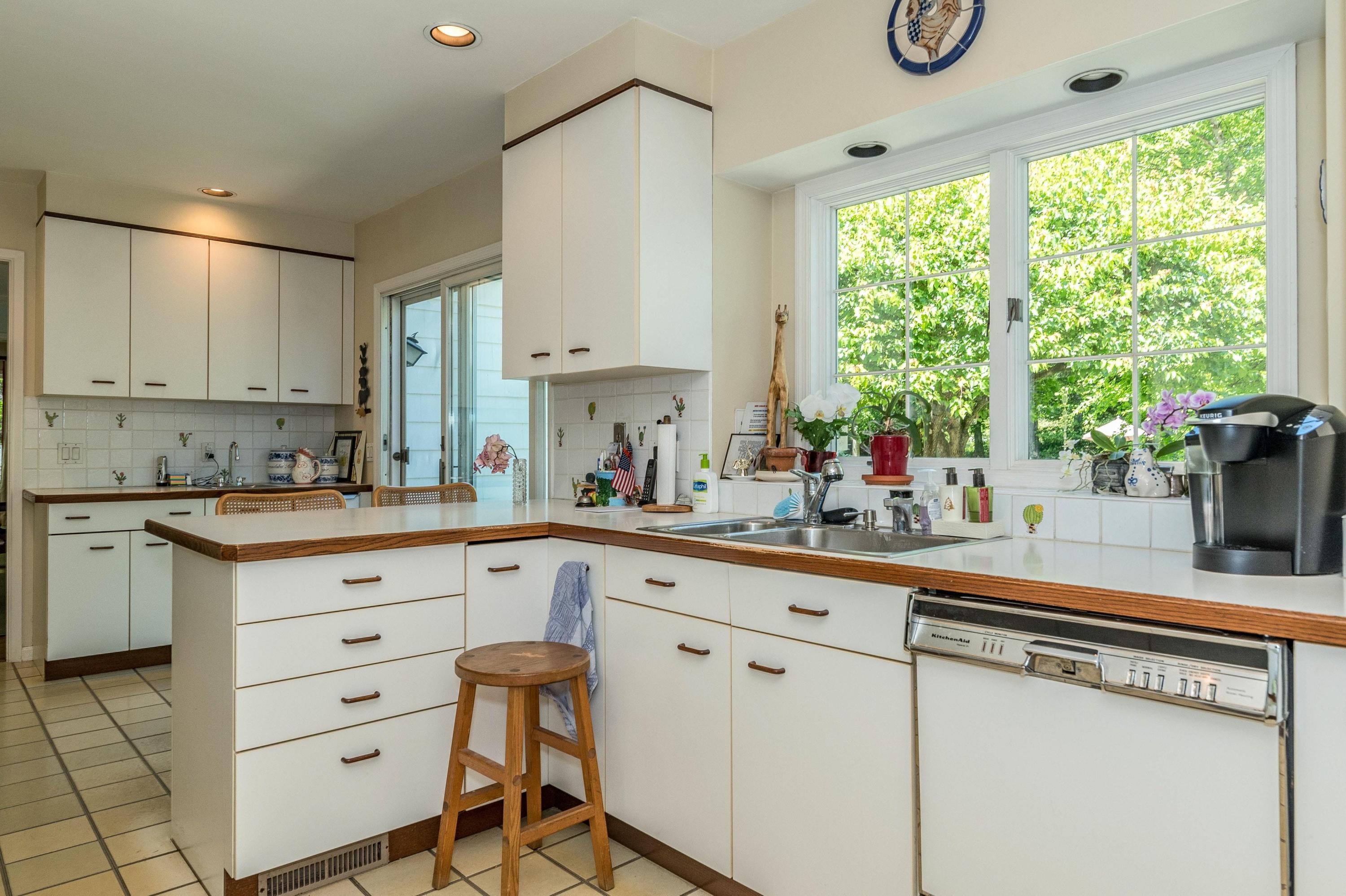 51 St Nicholas Road Darien, CT 06820 - Photo 11 of 34 a kitchen with a white cabinets and window