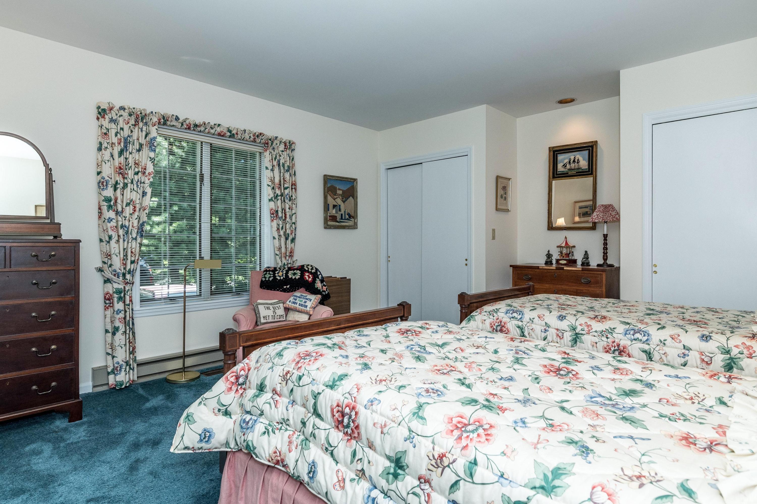 51 St Nicholas Road Darien, CT 06820 - Photo 20 of 34 a bedroom with a bed and a dresser next to a window