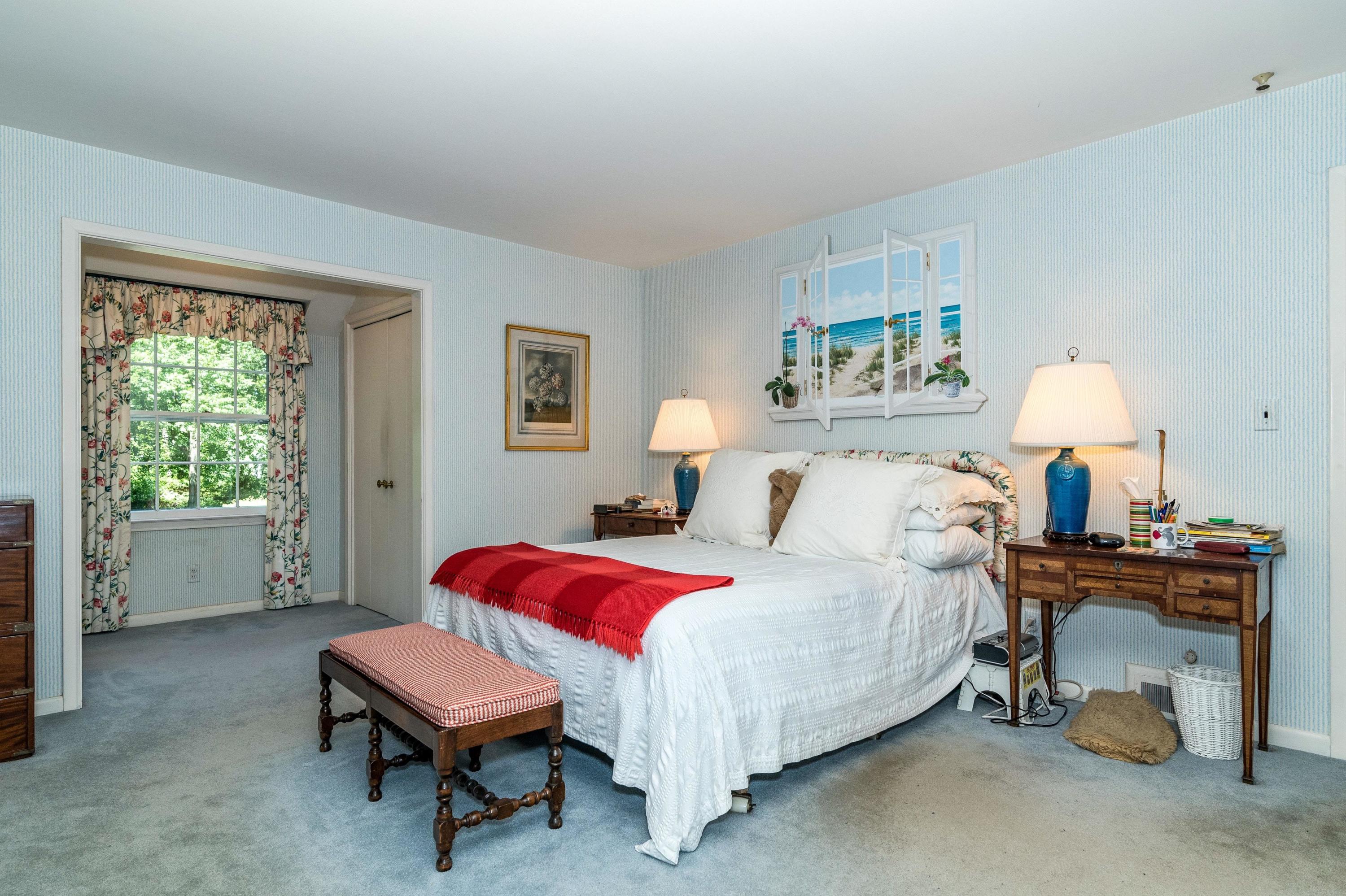 51 St Nicholas Road Darien, CT 06820 - Photo 23 of 34 a bedroom with a bed and a chandelier