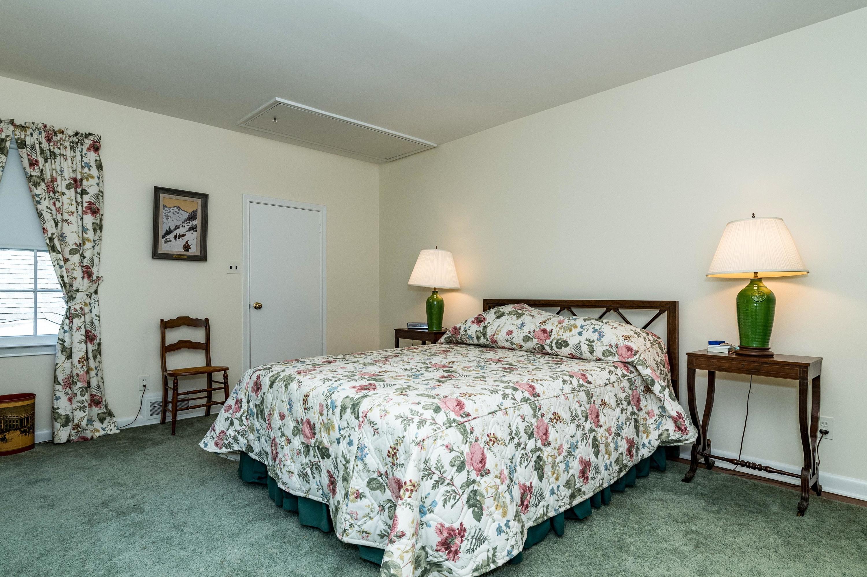 51 St Nicholas Road Darien, CT 06820 - Photo 24 of 34 a bedroom with a bed and a lamp on table