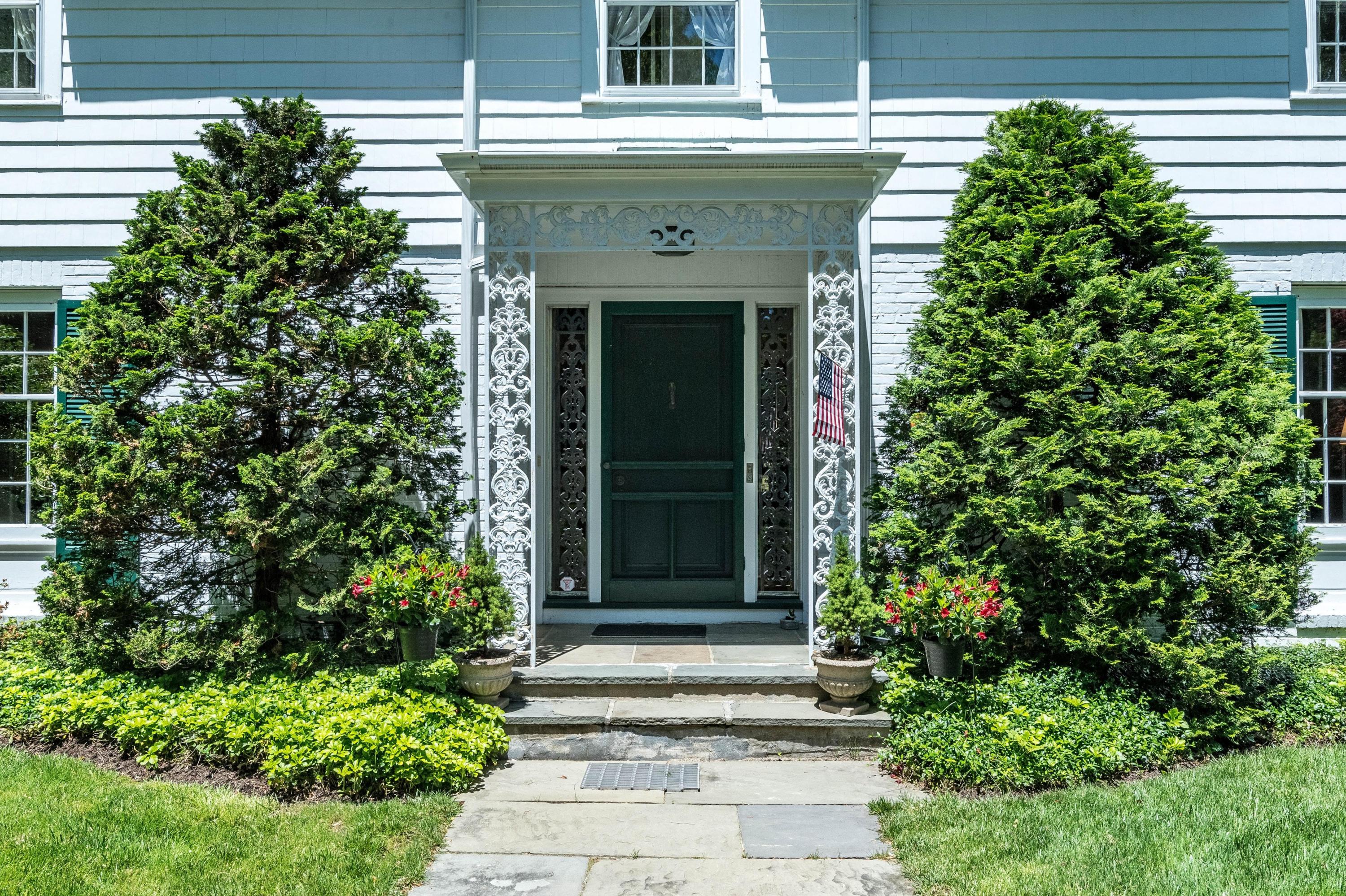 51 St Nicholas Road Darien, CT 06820 - Photo 4 of 34 a front view of a house with a garage
