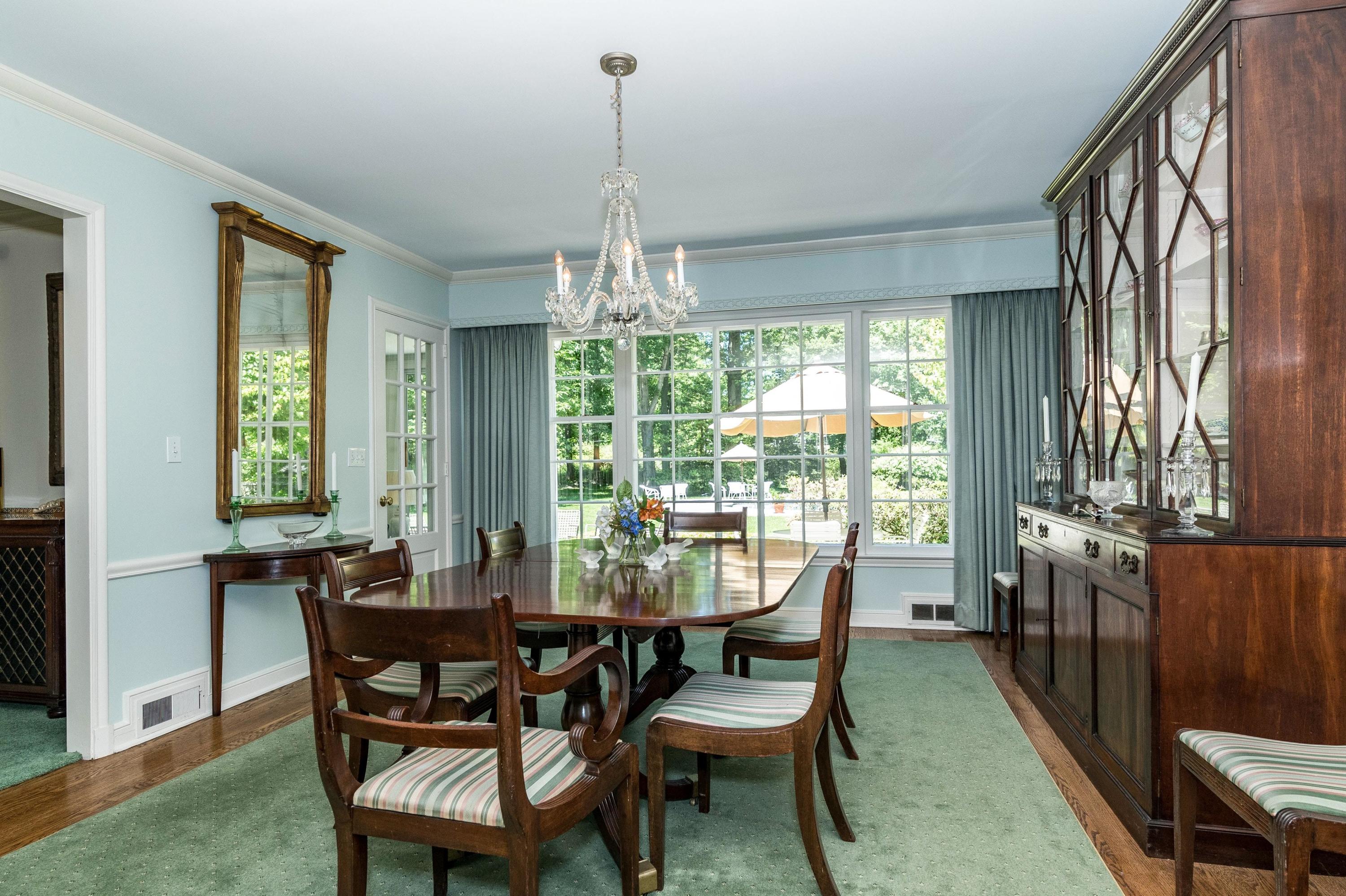 51 St Nicholas Road Darien, CT 06820 - Photo 9 of 34 a dining room with furniture a chandelier and wooden floor