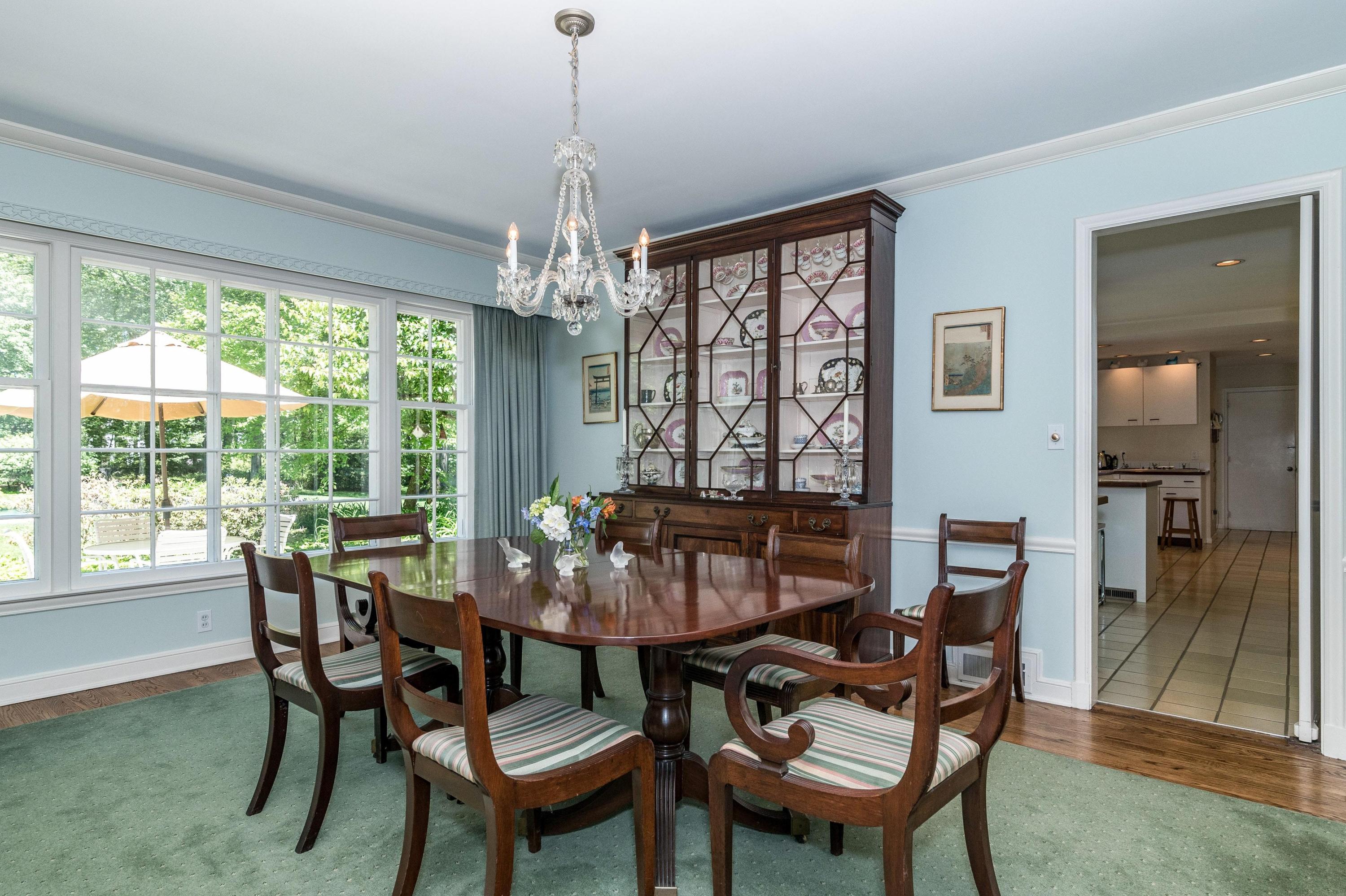 51 St Nicholas Road Darien, CT 06820 - Photo 10 of 34 a dining room with furniture a chandelier and wooden floor