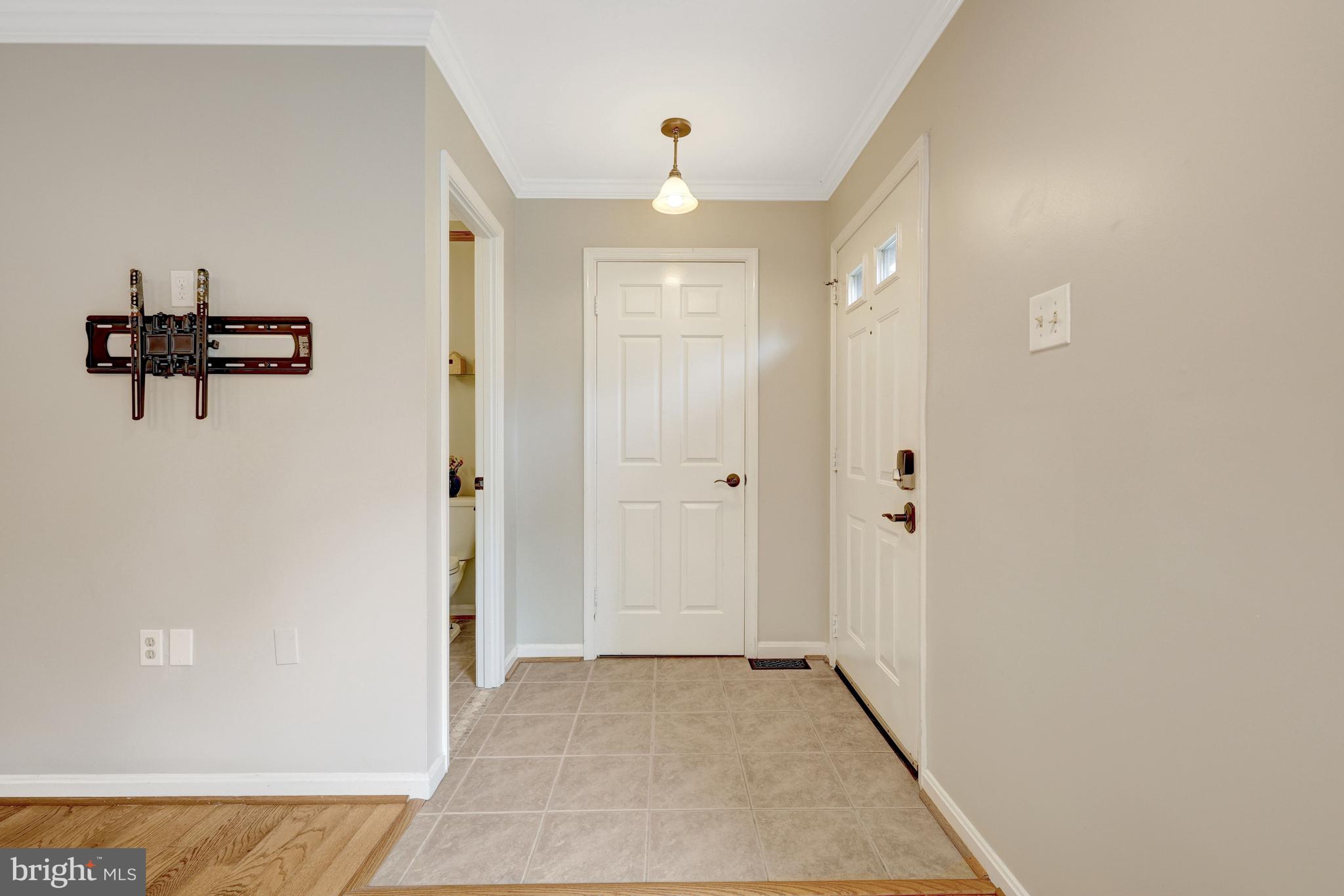 11992 Sentinel Point Court Reston, VA 20191 - Photo 6 of 49 Foyer to main level bath and family room