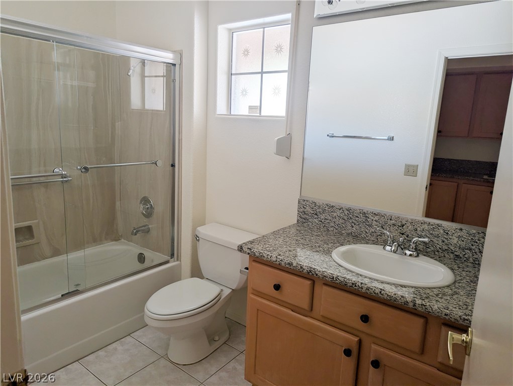 9433 Quail Ridge Drive Las Vegas, NV 89134 - Photo 14 of 23 A well-appointed bathroom with a bathtub, shower, toilet, and vanity featuring a granite countertop.
