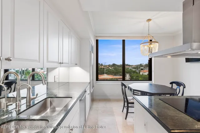 a kitchen with a table chairs and a granite counter top