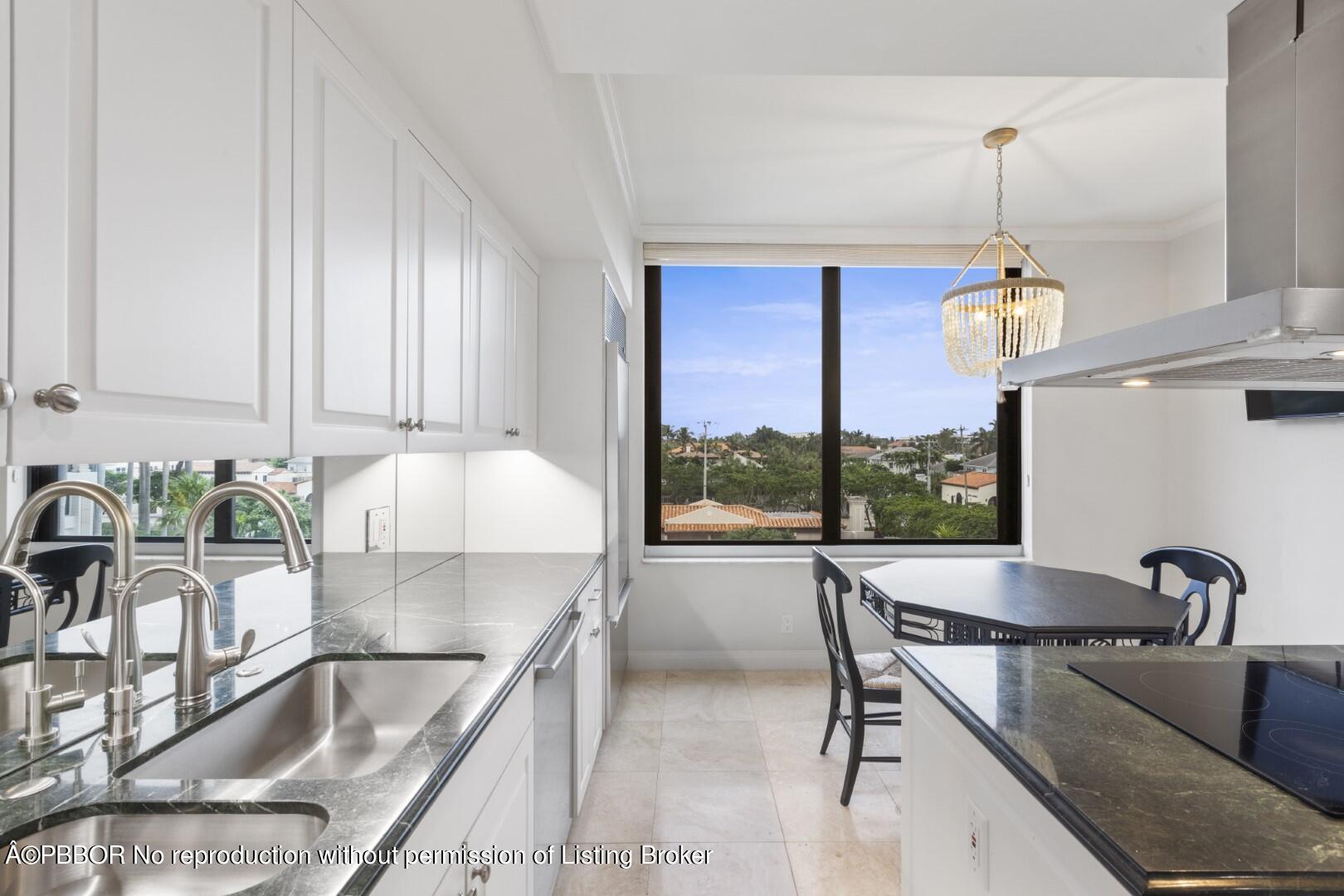 200 Bradley Place, Unit 301 Palm Beach, FL 33480 - Photo 11 of 34 a kitchen with a table chairs and a granite counter top