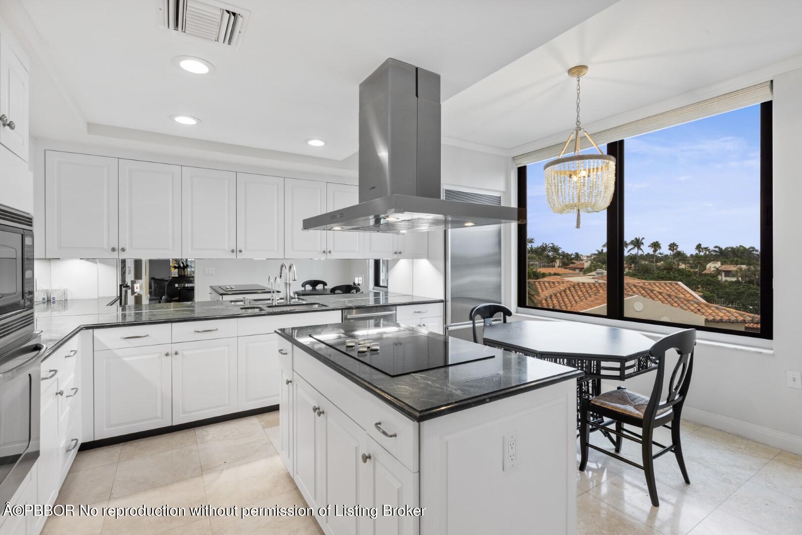 200 Bradley Place, Unit 301 Palm Beach, FL 33480 - Photo 15 of 34 a kitchen with stainless steel appliances granite countertop a sink a stove and a wooden cabinets