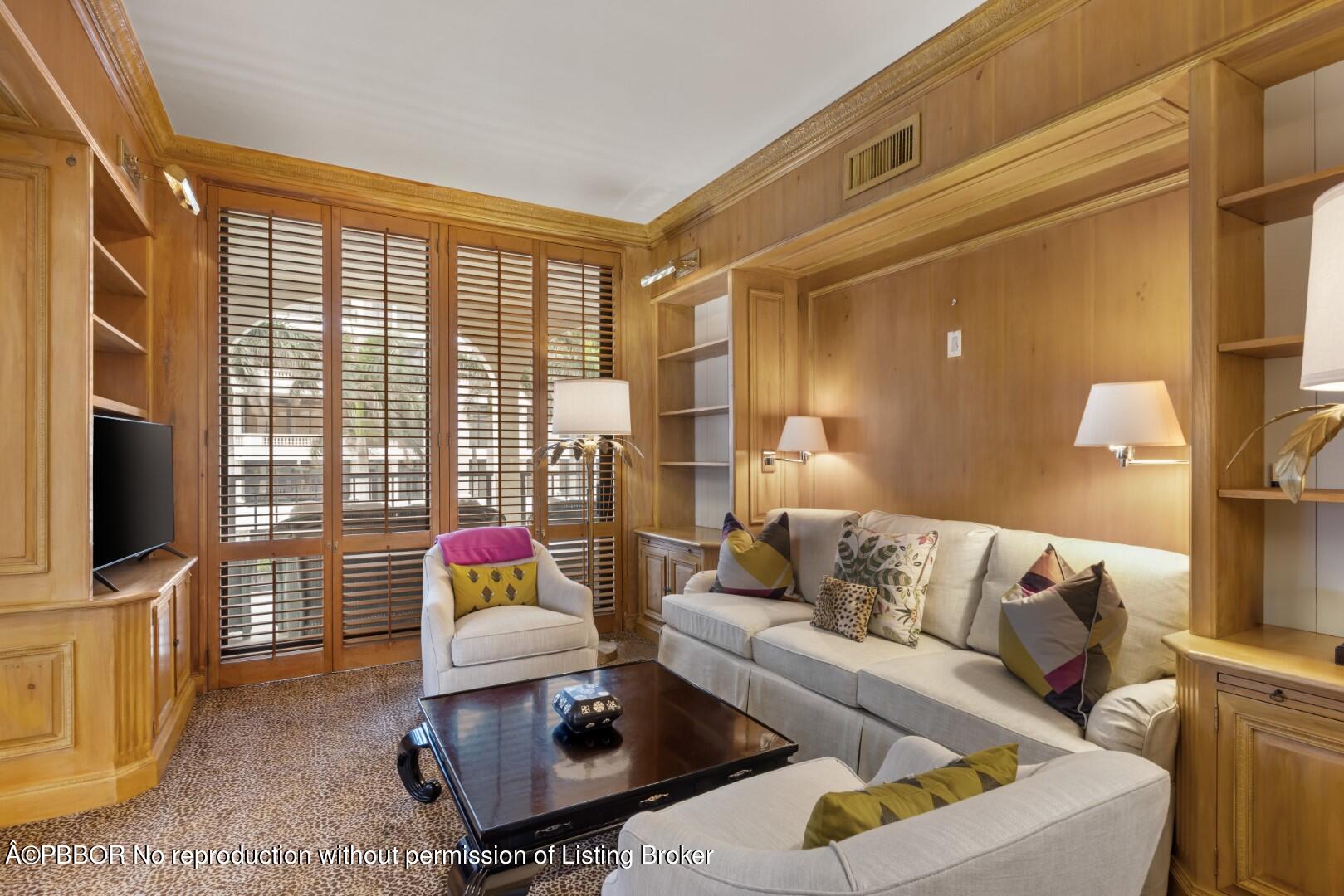 200 Bradley Place, Unit 301 Palm Beach, FL 33480 - Photo 18 of 34 a living room with furniture flat screen tv and a large window