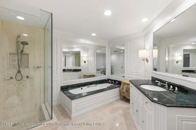 a large white kitchen with a sink and a large mirror
