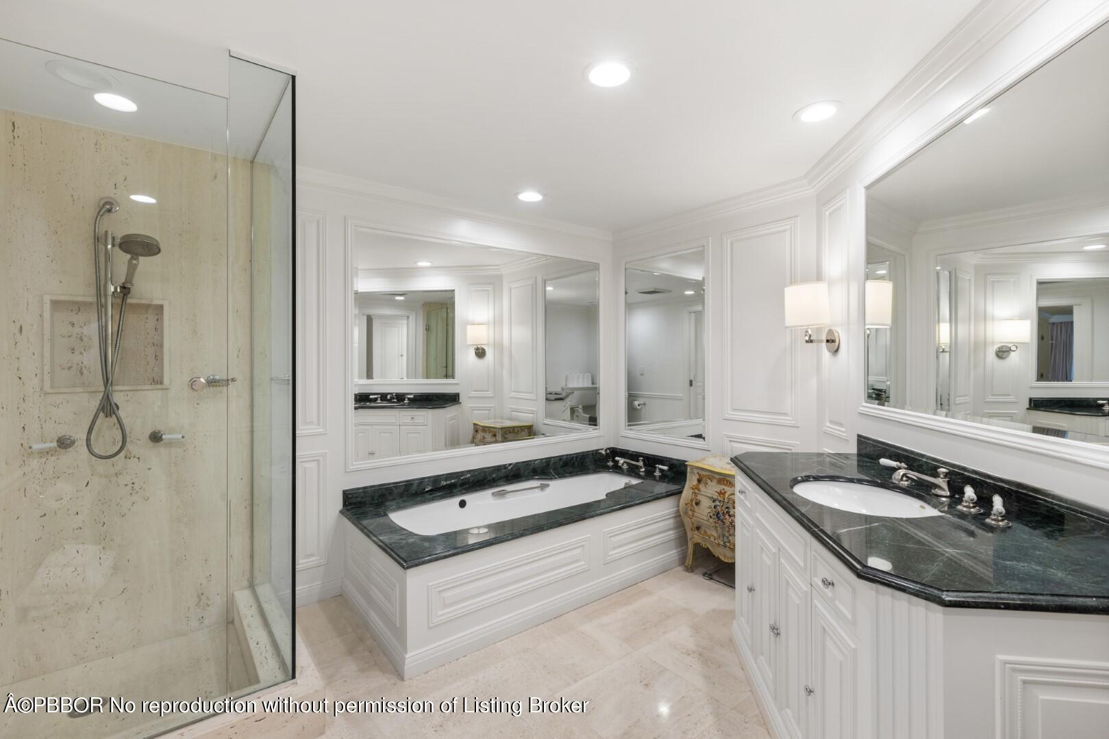 200 Bradley Place, Unit 301 Palm Beach, FL 33480 - Photo 21 of 34 a large white kitchen with a sink and a large mirror