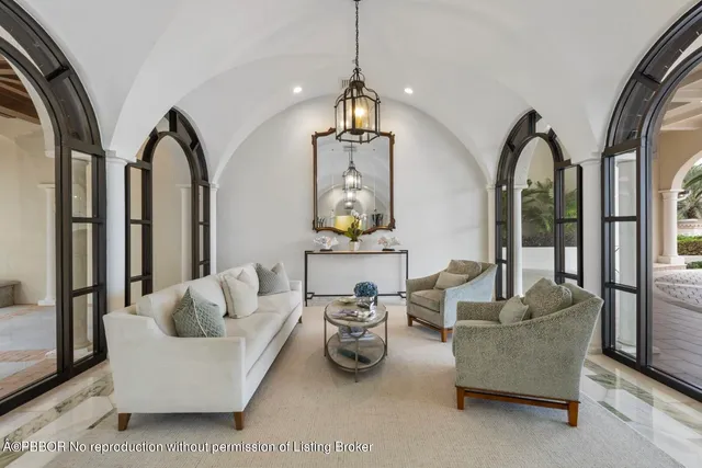 a living room with furniture a couch and a chandelier