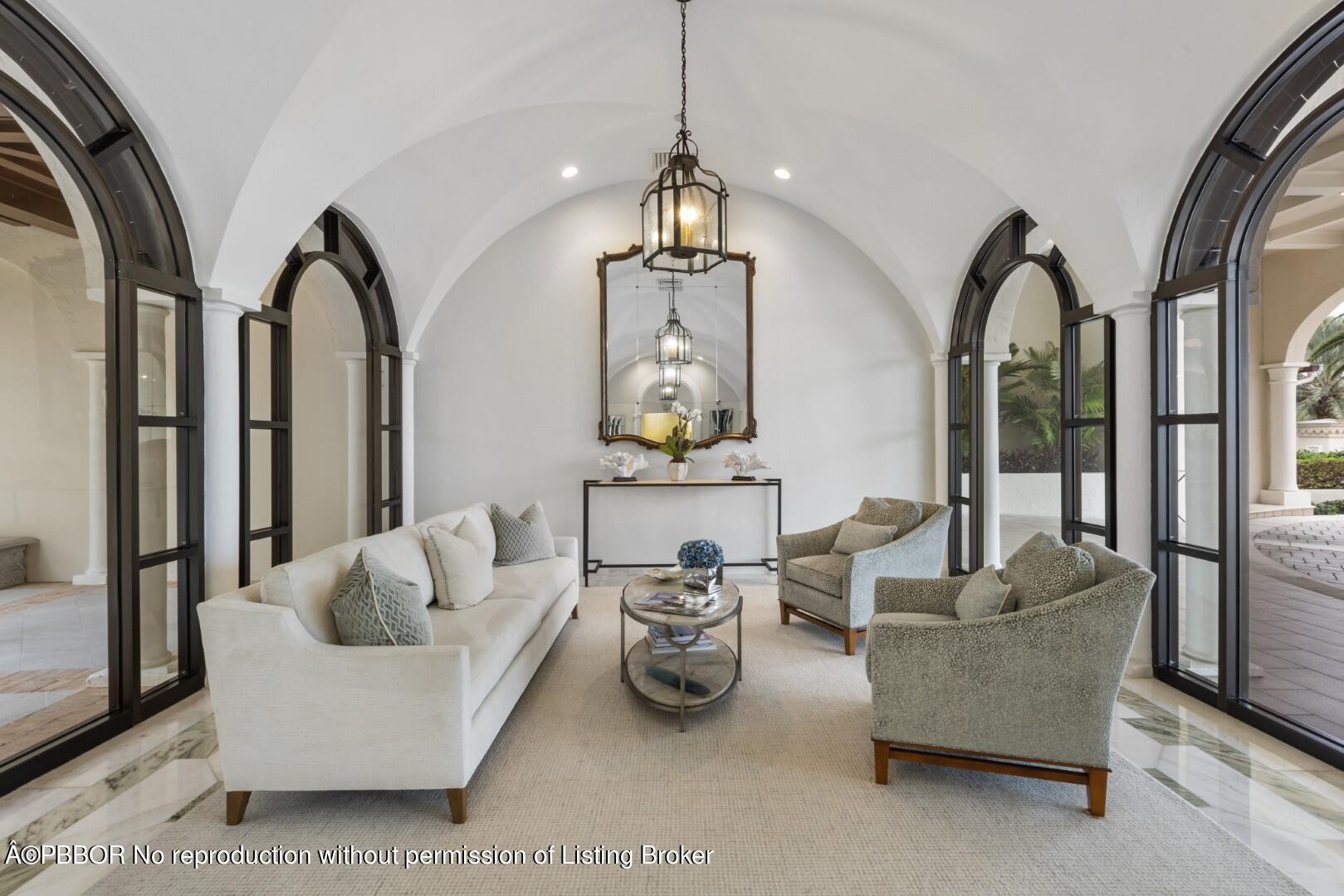 200 Bradley Place, Unit 301 Palm Beach, FL 33480 - Photo 28 of 34 a living room with furniture a couch and a chandelier