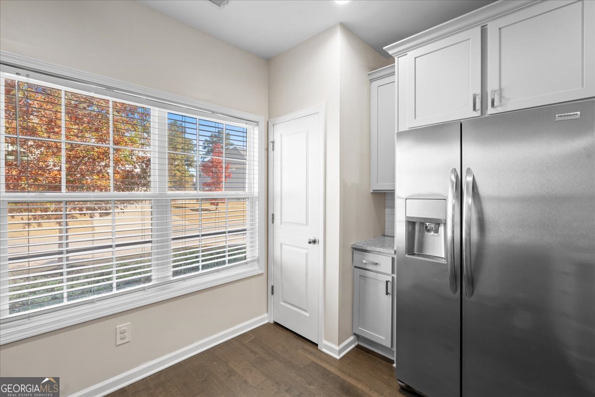 108 East River Cane Run Perry, GA 31069 - Photo 14 of 38 a view of a refrigerator in kitchen and an empty room