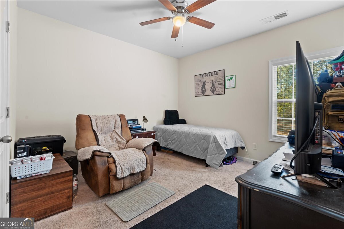 108 East River Cane Run Perry, GA 31069 - Photo 16 of 38 a bedroom with a bed and a flat screen tv