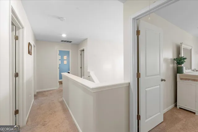 a view of entryway with white cabinets