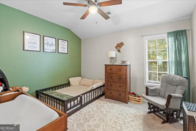 a bedroom with furniture and a window