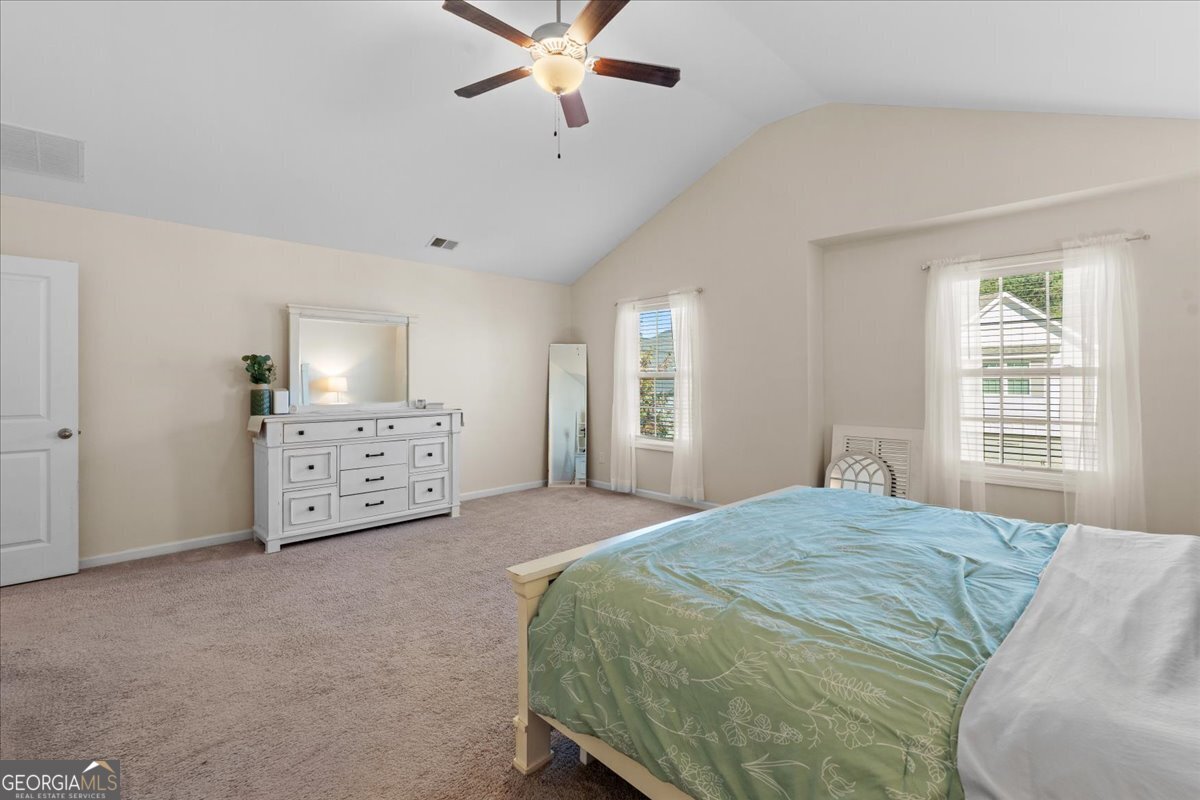 108 East River Cane Run Perry, GA 31069 - Photo 27 of 38 a spacious bedroom with a bed and a chandelier