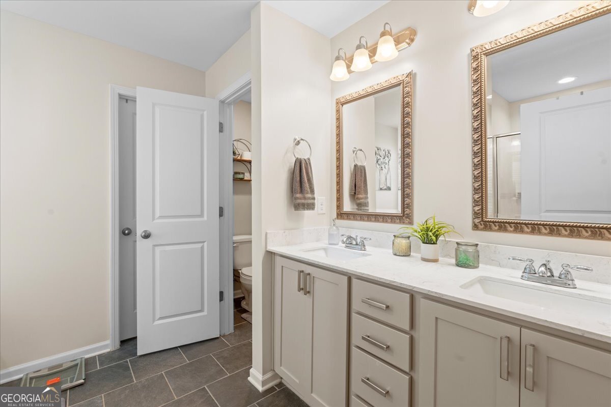 108 East River Cane Run Perry, GA 31069 - Photo 29 of 38 a bathroom with a double vanity sink mirror and next to a window