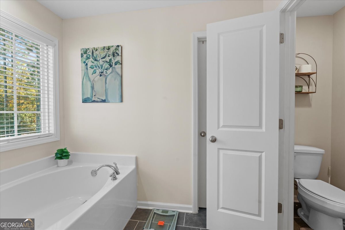 108 East River Cane Run Perry, GA 31069 - Photo 30 of 38 a white bath tub sitting next to a toilet