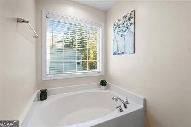 a white bath tub sitting next to a window