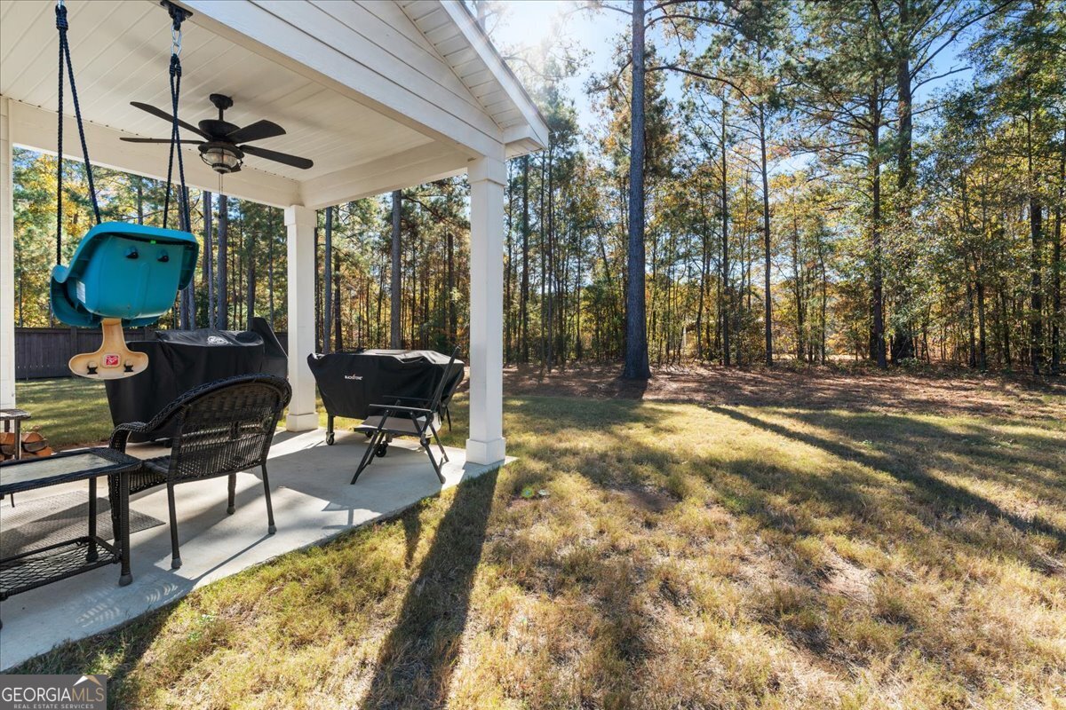 108 East River Cane Run Perry, GA 31069 - Photo 36 of 38 a backyard of a house with table and chairs