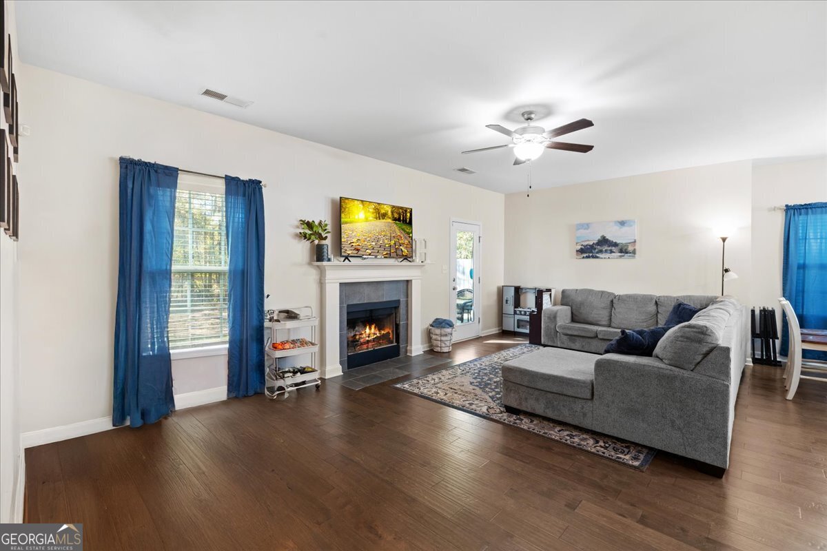 108 East River Cane Run Perry, GA 31069 - Photo 6 of 38 a living room with furniture a fireplace and a flat screen tv