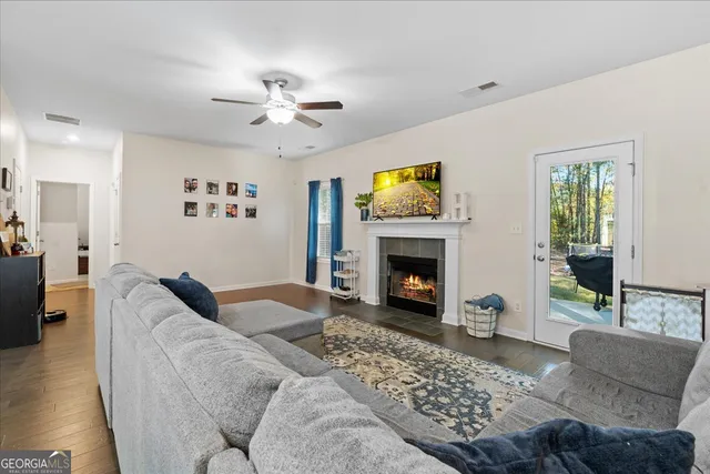a living room with furniture a flat screen tv and a fireplace
