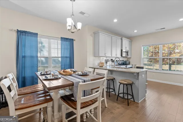 a view of a dining room with furniture window and wooden floor