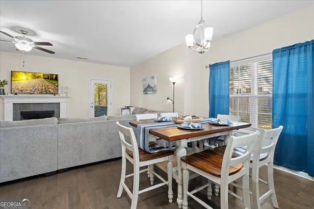 a view of a dining room with furniture wooden floor and chandelier