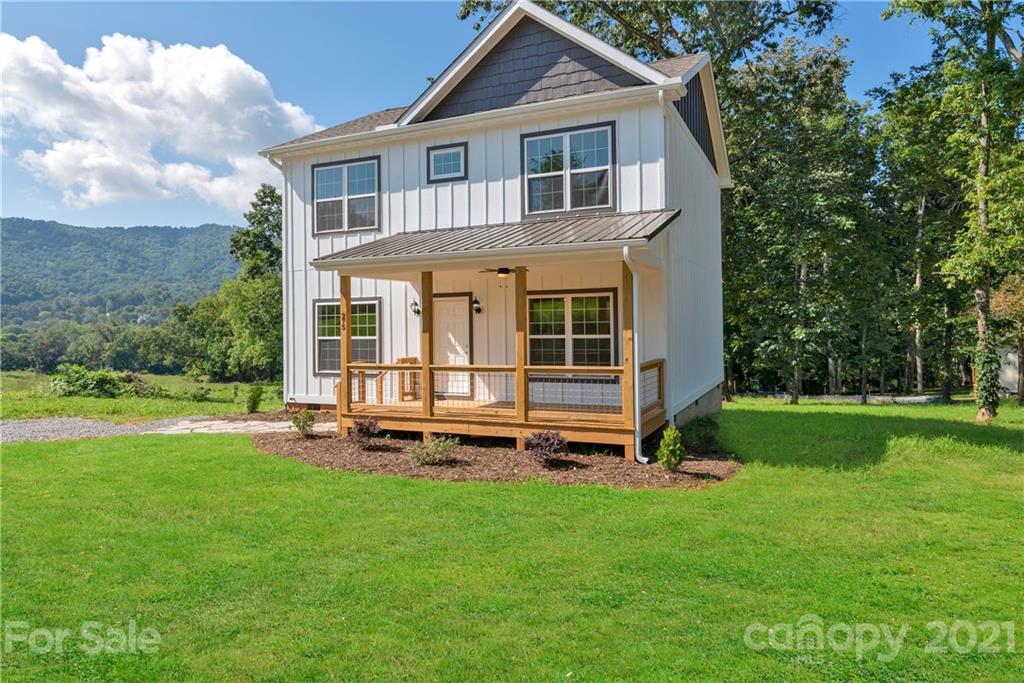 275 Ridge View Drive, Unit 1 Clyde, NC 28721 - Photo 2 of 22 a front view of a house with a yard table and chairs