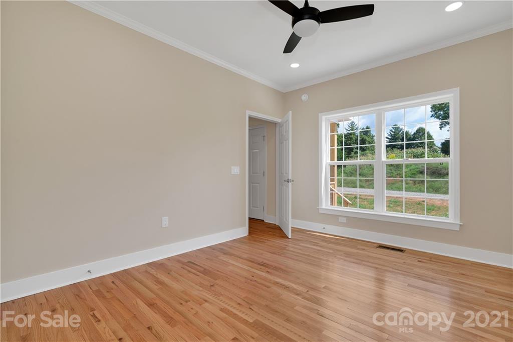275 Ridge View Drive, Unit 1 Clyde, NC 28721 - Photo 12 of 22 wooden floor in an empty room with a window