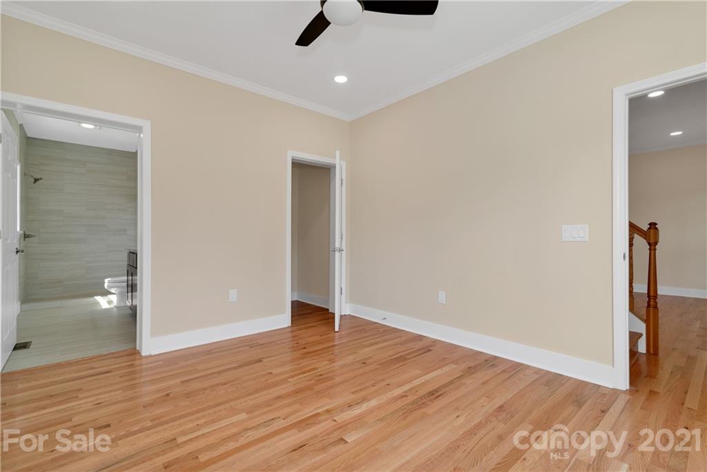 275 Ridge View Drive, Unit 1 Clyde, NC 28721 - Photo 13 of 22 wooden floor in an empty room with a bathroom