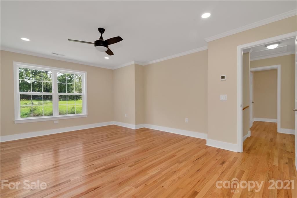 275 Ridge View Drive, Unit 1 Clyde, NC 28721 - Photo 16 of 22 a view of empty room with wooden floor and fan