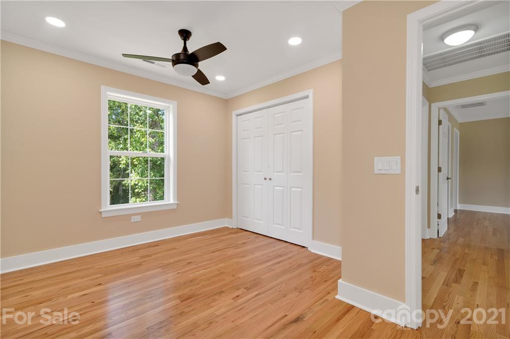 275 Ridge View Drive, Unit 1 Clyde, NC 28721 - Photo 20 of 22 a view of empty room with wooden floor and fan
