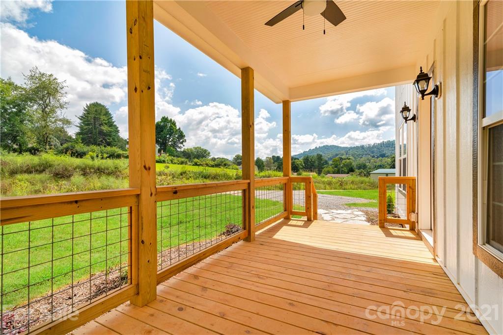 275 Ridge View Drive, Unit 1 Clyde, NC 28721 - Photo 4 of 22 a view of a balcony with a floor to ceiling window with wooden floor