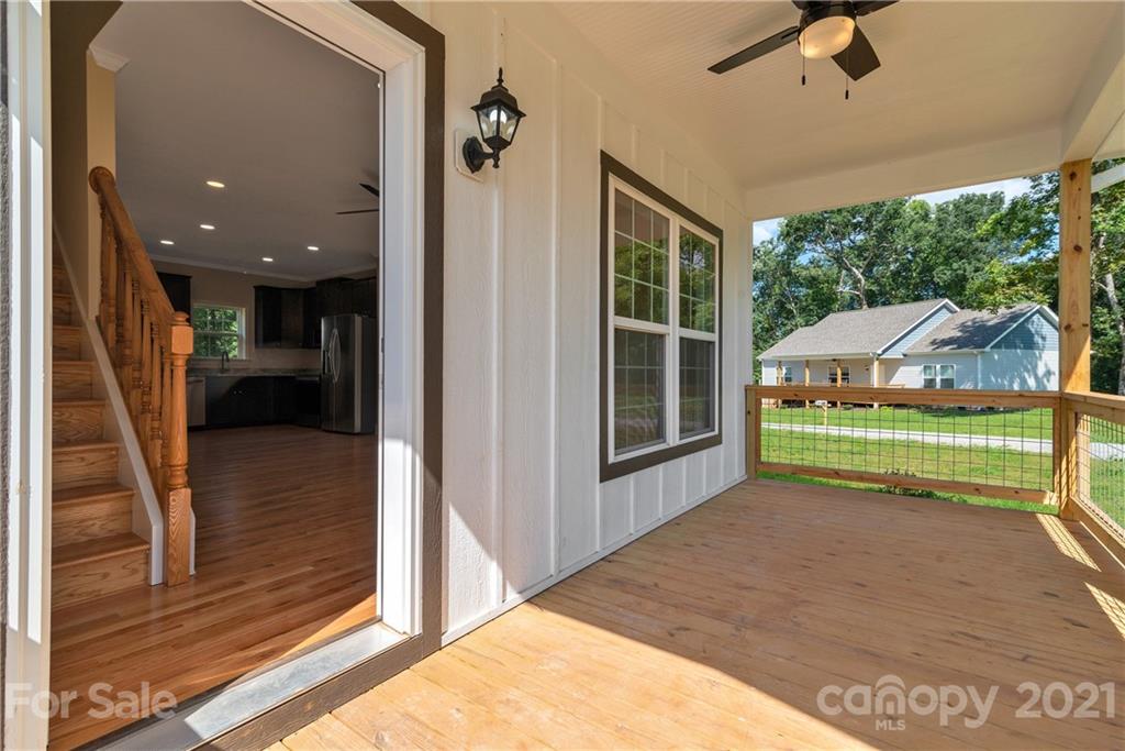 275 Ridge View Drive, Unit 1 Clyde, NC 28721 - Photo 5 of 22 a view of a porch with wooden floor and a yard