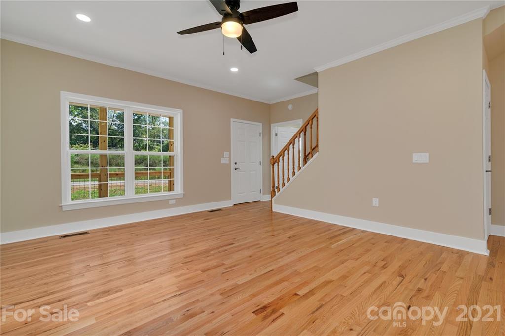 275 Ridge View Drive, Unit 1 Clyde, NC 28721 - Photo 6 of 22 a view of an empty room with wooden floor and a window