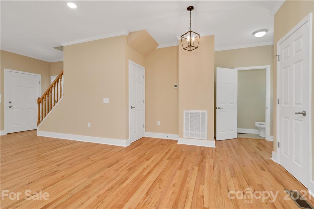 275 Ridge View Drive, Unit 1 Clyde, NC 28721 - Photo 7 of 22 a view of a room with wooden floor and a ceiling fan
