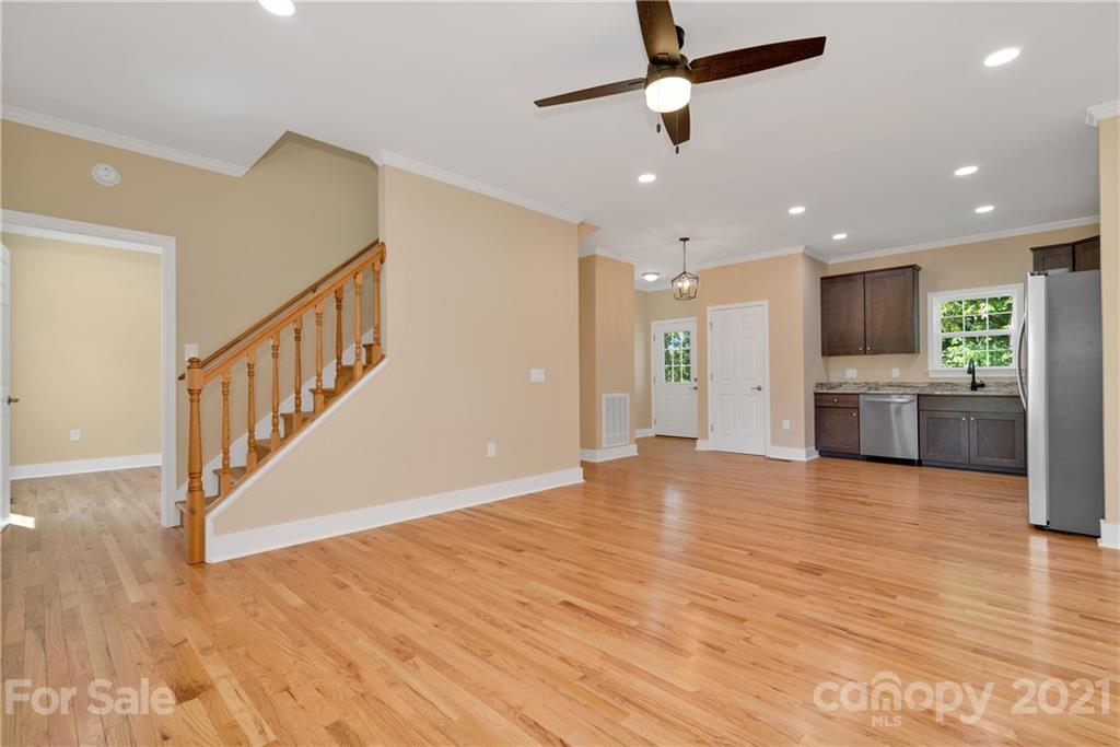 275 Ridge View Drive, Unit 1 Clyde, NC 28721 - Photo 8 of 22 a view of empty room with wooden floor and ceiling fan