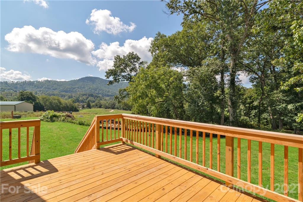 275 Ridge View Drive, Unit 1 Clyde, NC 28721 - Photo 9 of 22 a view of balcony with wooden floor and lake view