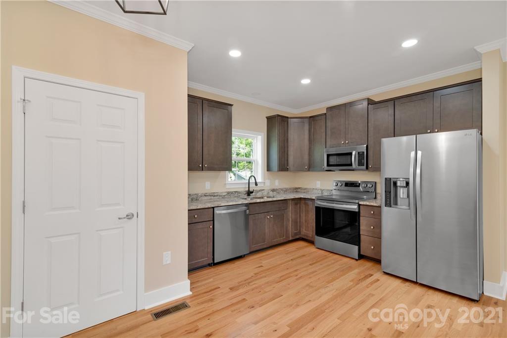 275 Ridge View Drive, Unit 1 Clyde, NC 28721 - Photo 10 of 22 a kitchen with stainless steel appliances granite countertop a refrigerator and a sink