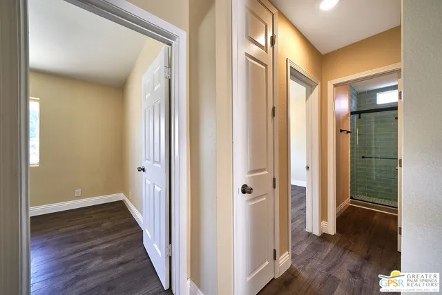 a view of a hallway with wooden floor