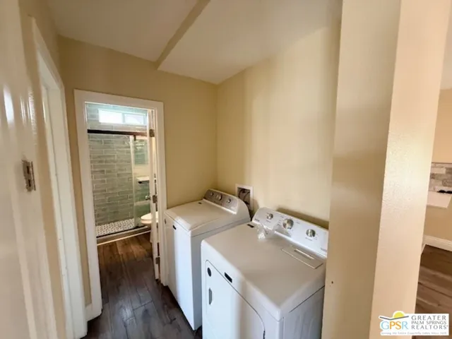 a view of a hallway with wooden floor and closet