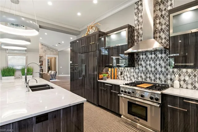 a kitchen with a stove a sink and a refrigerator